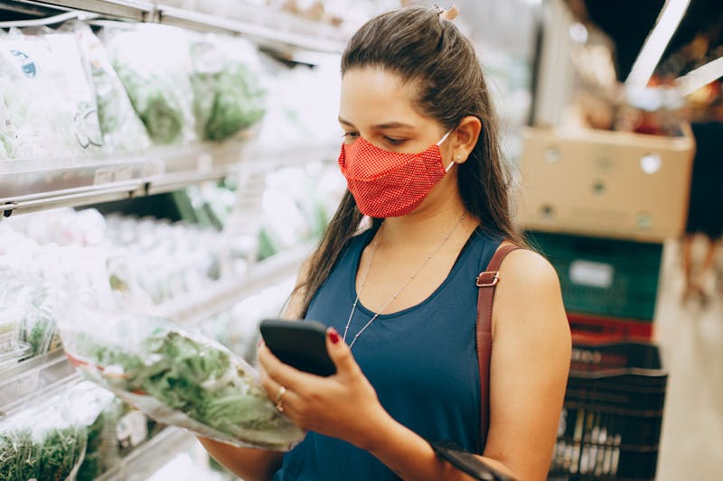 a woman checking the price of a product